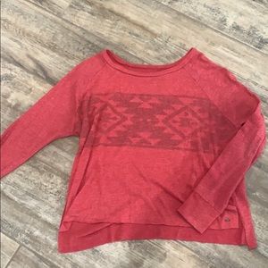 Pink sweater with pattern across chest